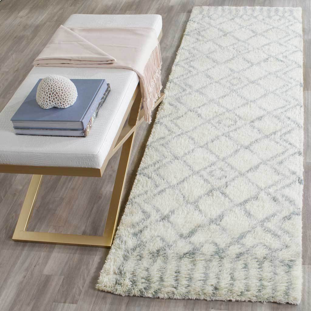 A plush ivory runner brings gentle pattern to the floor with muted blue diamonds and end accents.