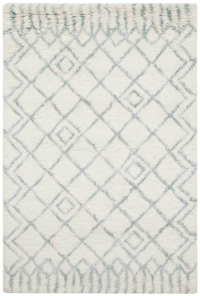 Pale blue inset diamonds punctuate an ivory rug with geometric borders