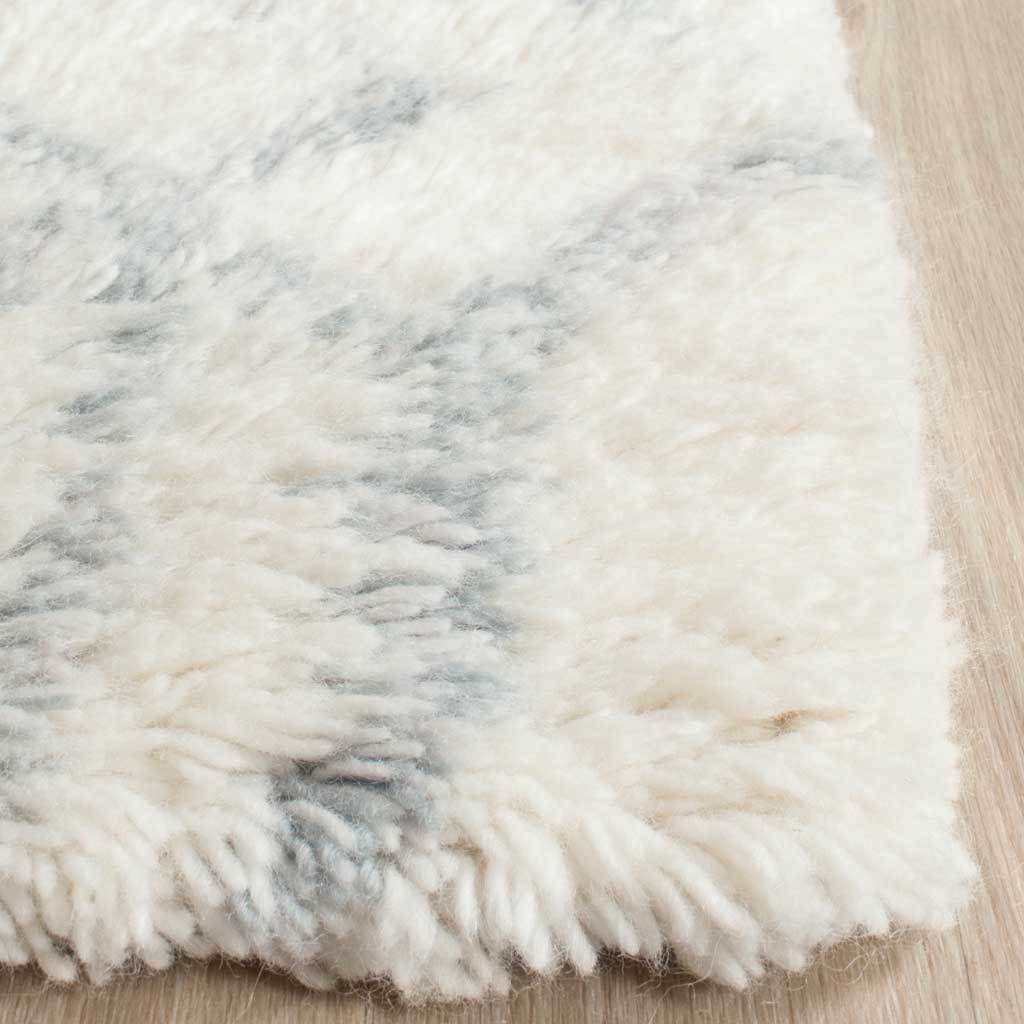 Ivory-and-blue pile forms a soft, textured rug corner