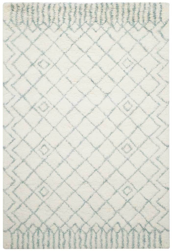 Soft blue diamonds trace across a thick ivory shag rug