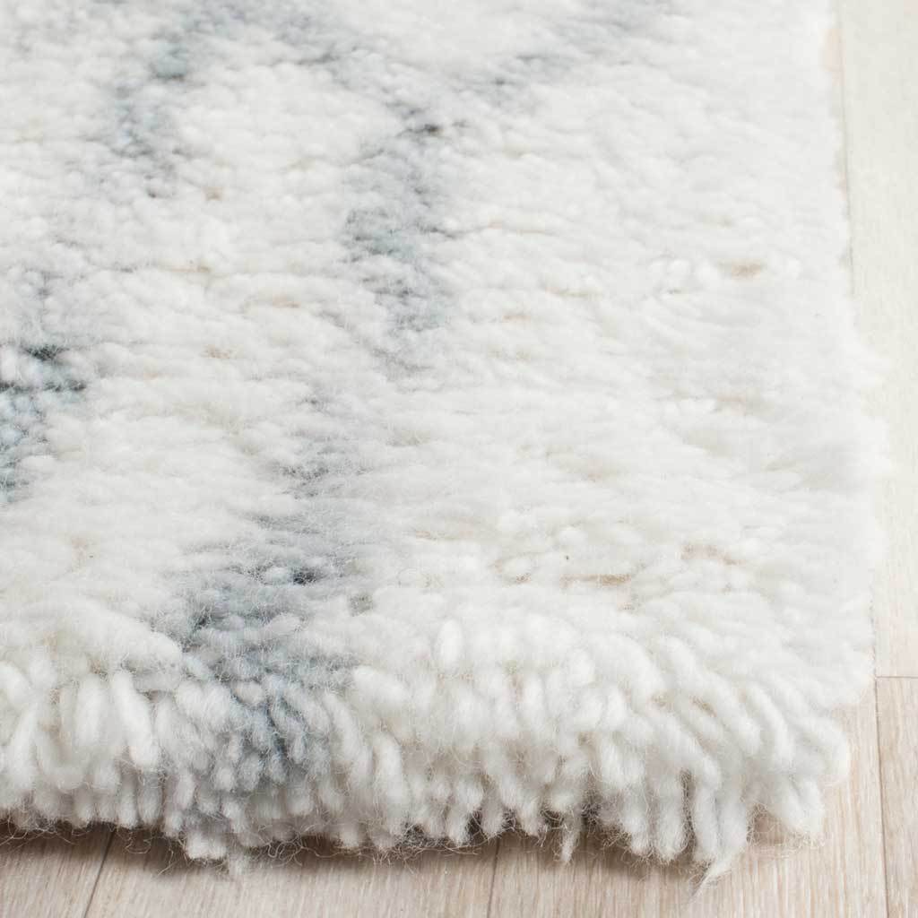 Thick ivory shag shows faint blue accents along its fluffy corner