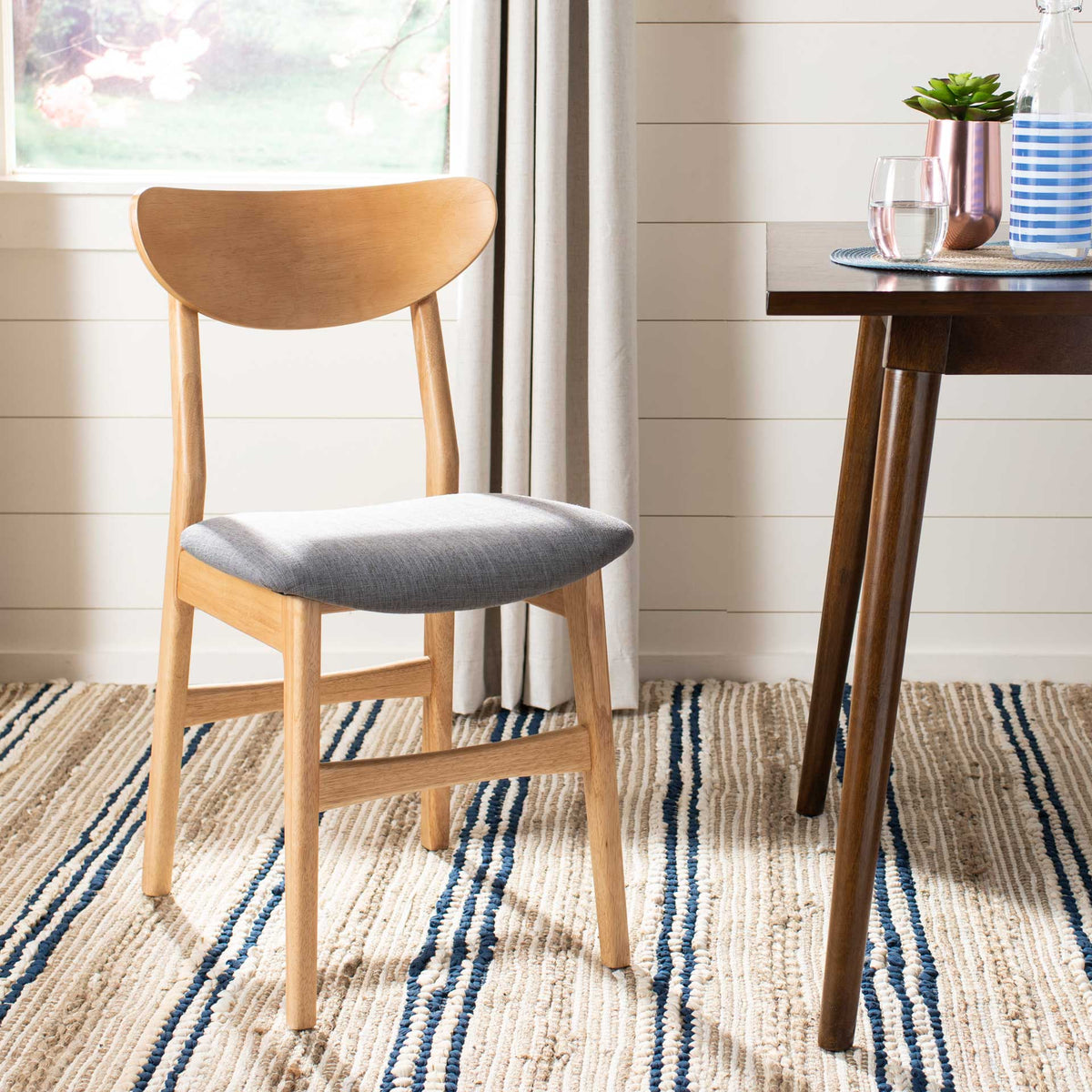 A natural wood chair brings a softly padded gray seat to a cozy dining corner