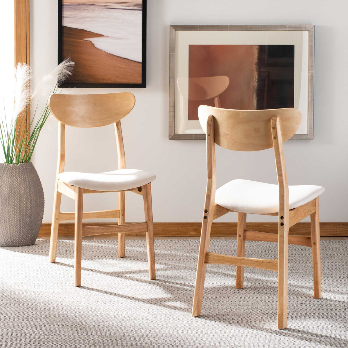 Pale wood dining chairs pair gently curved backs with soft white seats