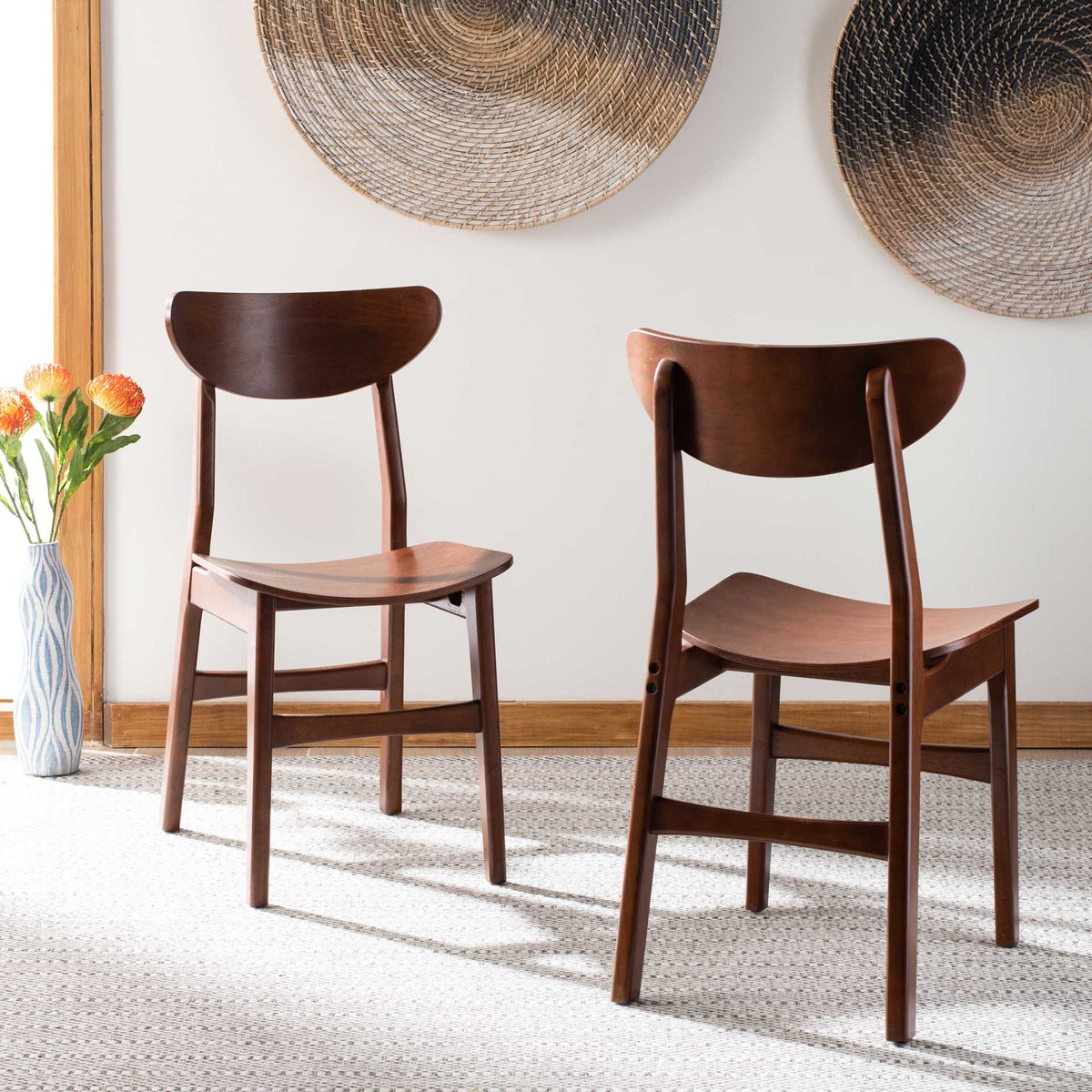 Matching walnut-finished chairs add warm wood texture and curved lines to the dining space