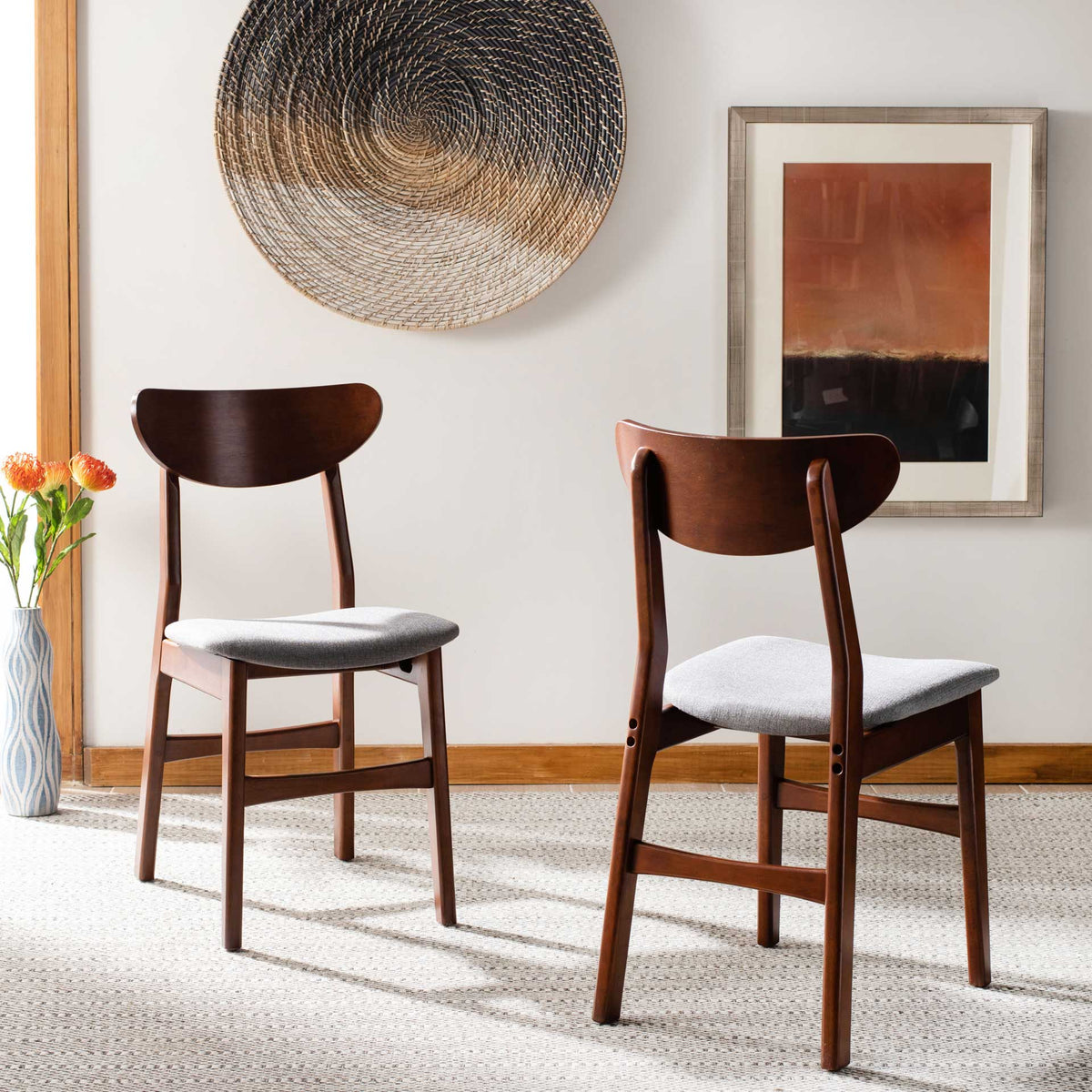 Walnut-finished dining chairs brighten the space with soft gray cushioned seats