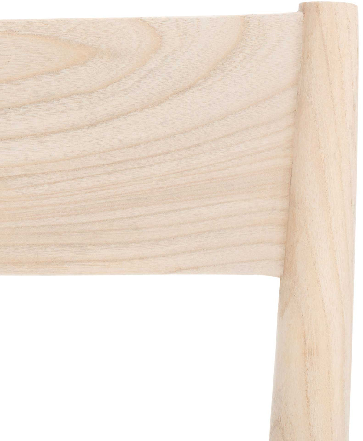 Soft natural wood grain traces the broad upper rail of the dining chair