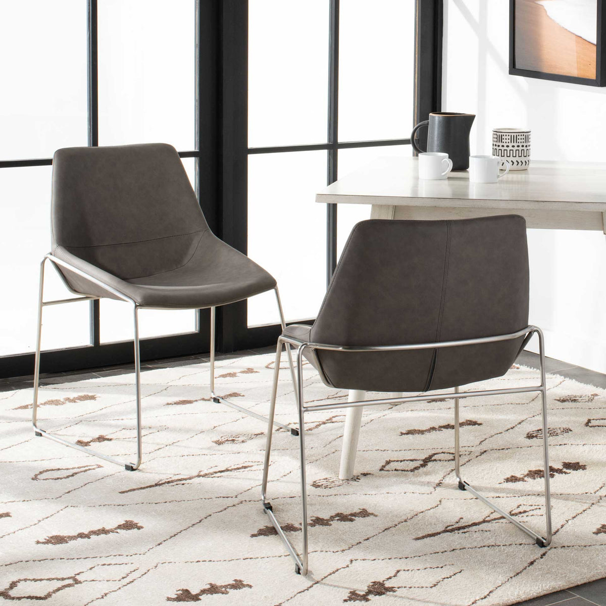 Seamed ash gray chair backs complement smooth seats and slender silver frames in this matching pair