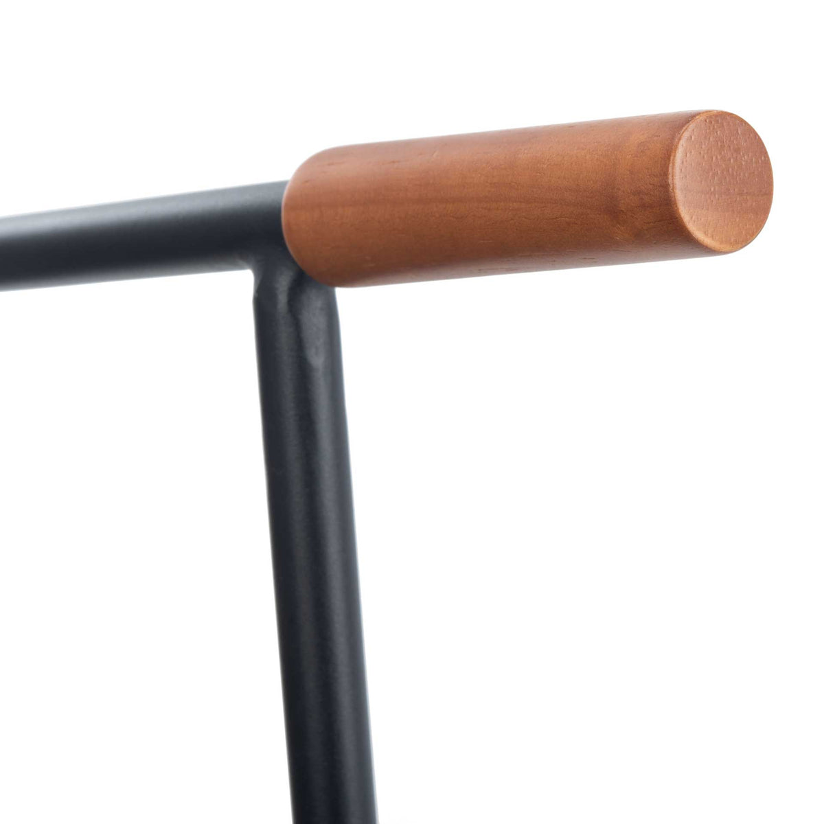 A warm wood-tone arm cap tops the chair's streamlined black metal armrest