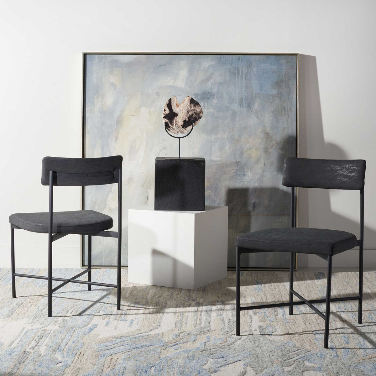 Black upholstered dining chairs bring clean-lined, retro-inspired comfort to modern decor