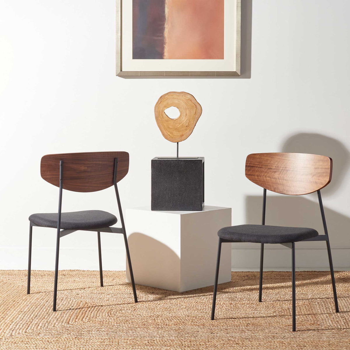 Walnut wood grain and black upholstery give this pair of dining chairs a warm, modern feel.