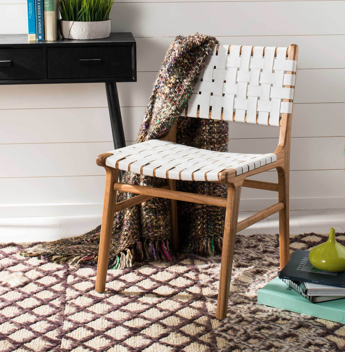 A white woven leather seat and open wood frame bring relaxed texture to a cozy space