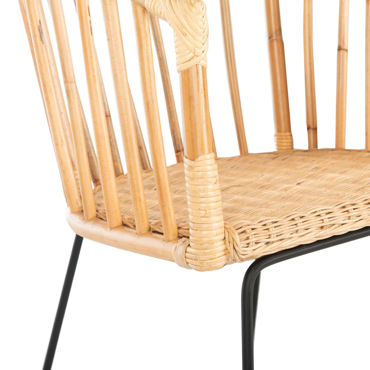 Woven rattan seat and tightly wrapped corner meet a slender black metal frame