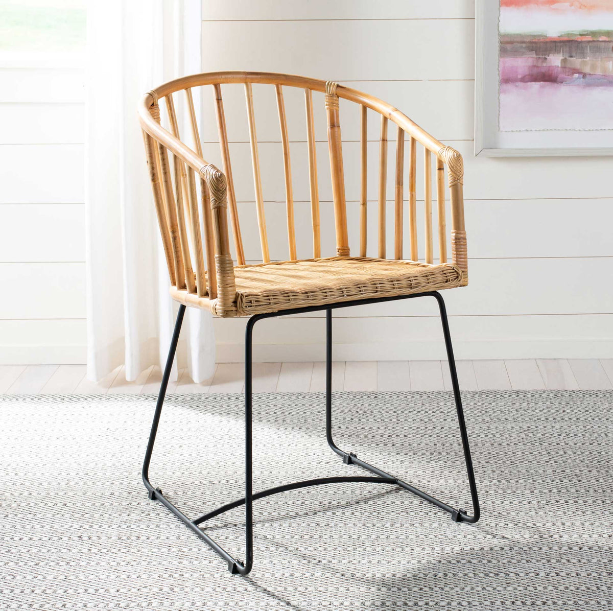 Warm rattan curves and slender black legs lend airy style to a bright dining space
