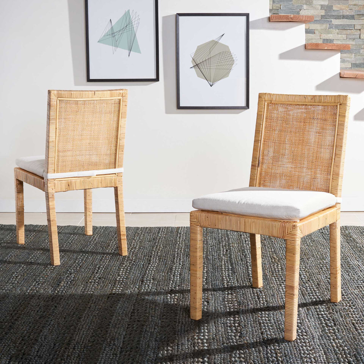 Two cane dining chairs pair natural woven texture with inviting white cushioned seats