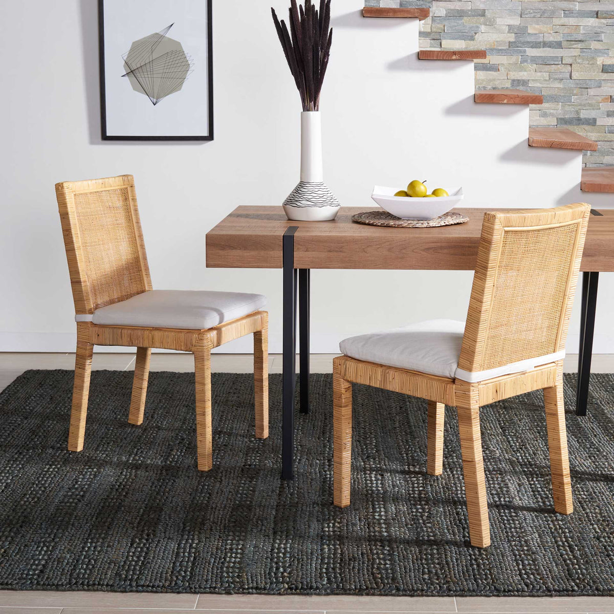 Natural rattan chairs with white cushions bring easygoing comfort to the dining table