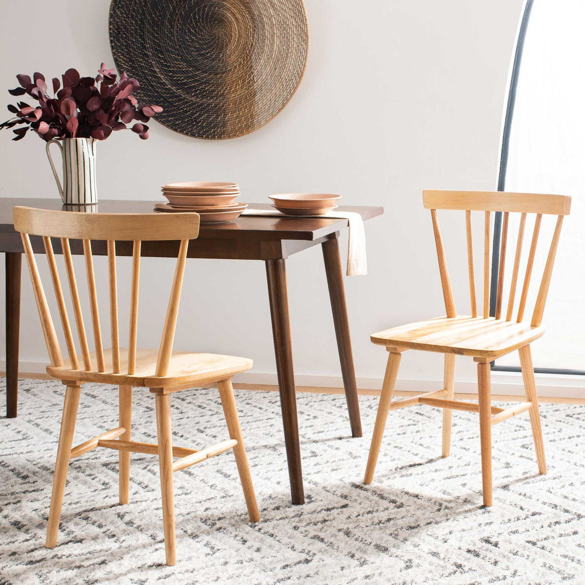 Natural wood dining chairs add light, rustic character around a dark wood table