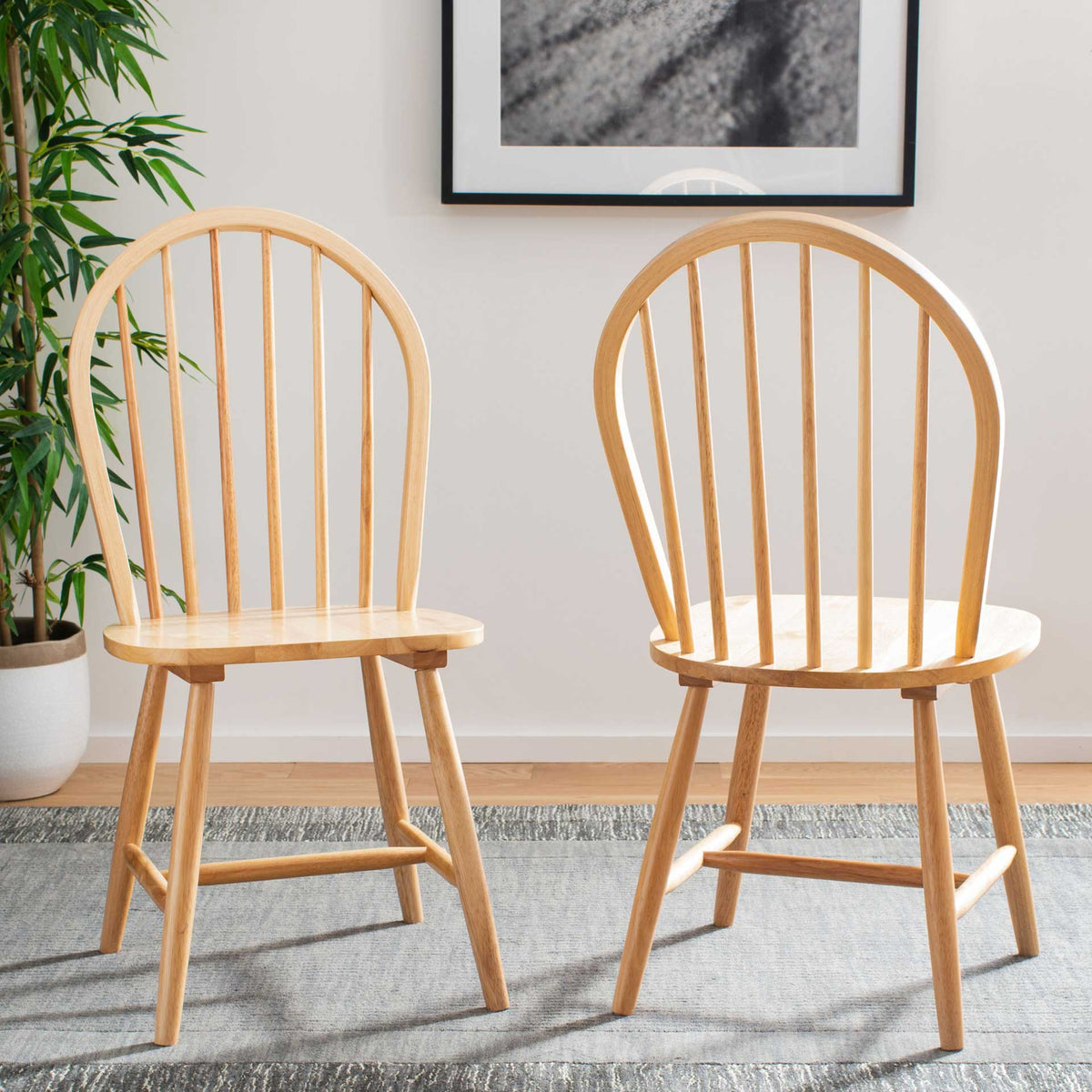 Two light wood spindle-back chairs add warmth and airy lines to the dining space