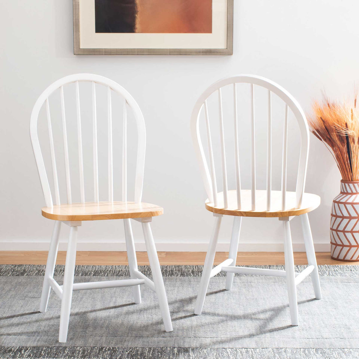 Two white spindle-back chairs showcase natural wood seats for easygoing contrast