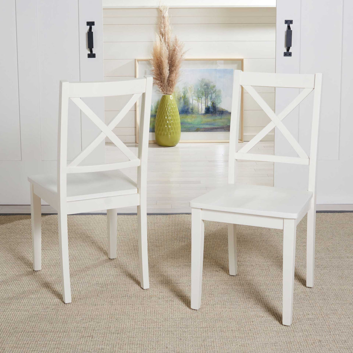 A matching pair of white X-back chairs adds crisp farmhouse charm to a dining space.