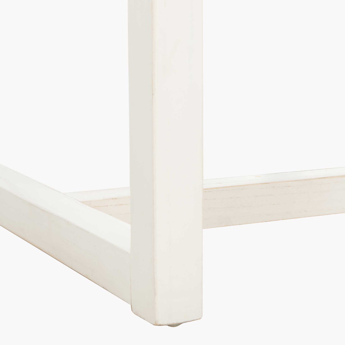 A square white-painted elm leg joins low connecting rails to form an airy base