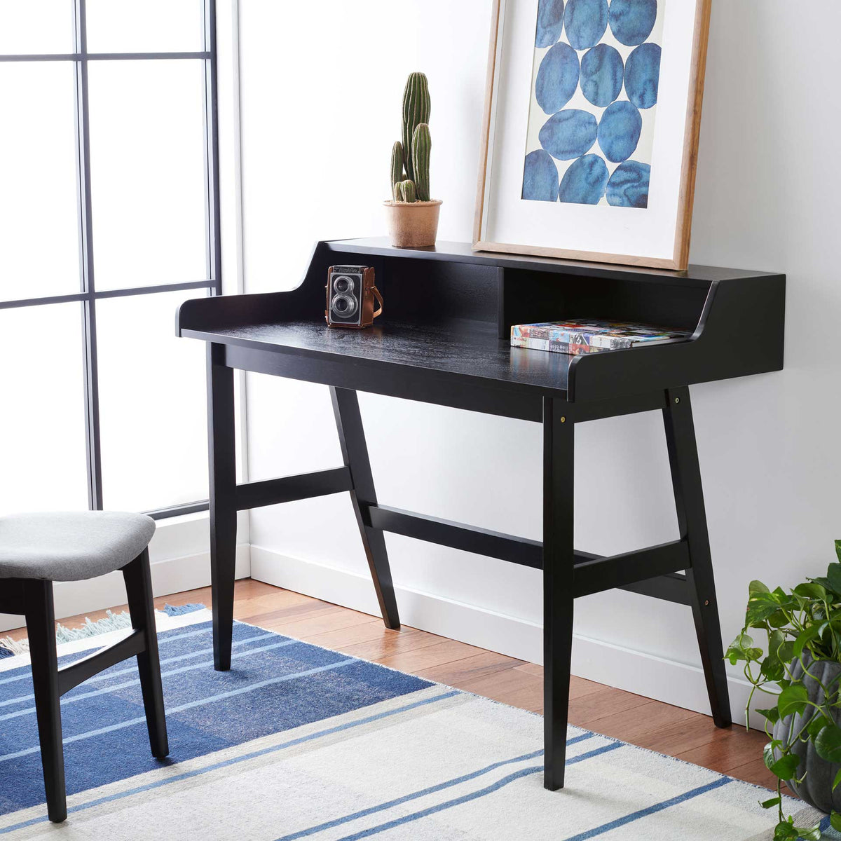 Matte black desk with an elevated display shelf and generous writing space