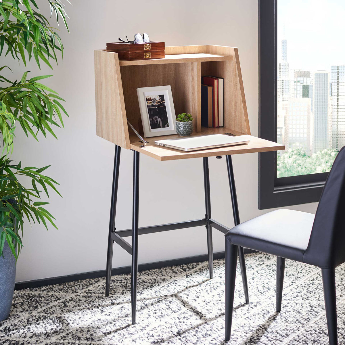 The fold-down wood-look writing surface opens to divided storage for books and small decor.