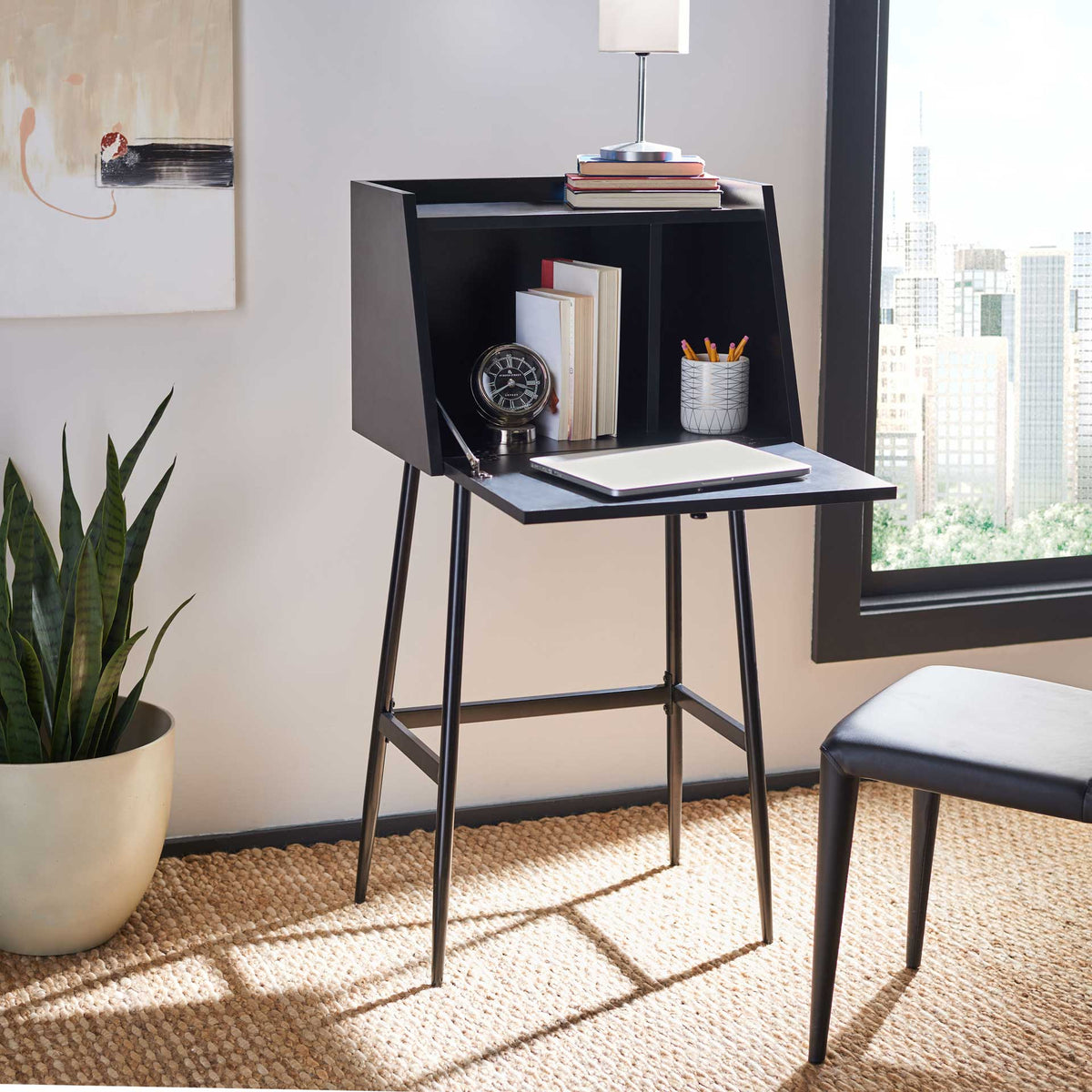 The black fold-down writing surface opens to storage cubbies for books, pencils, and essentials.
