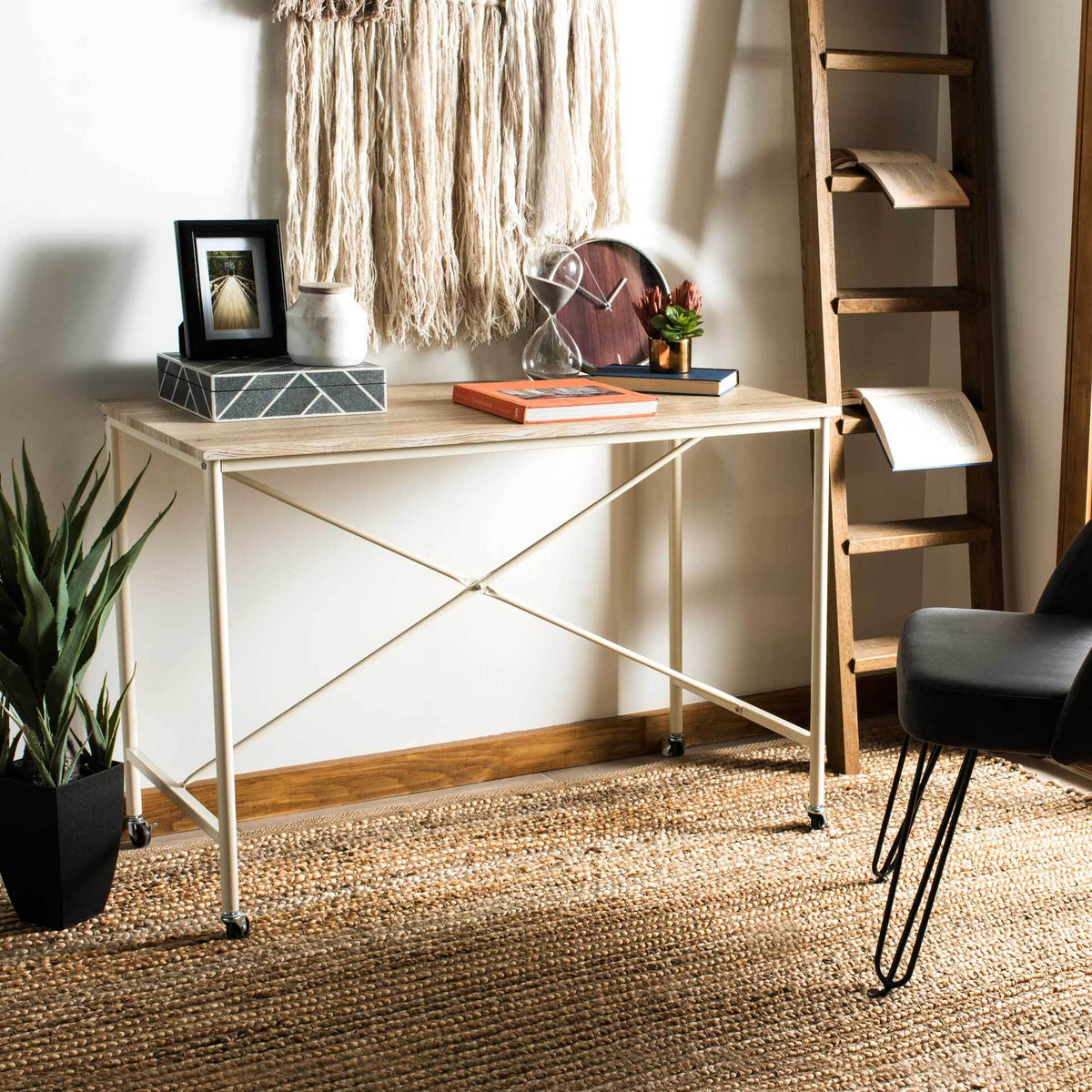 A pale wood-look top and cream X-braced frame create a flexible workspace on wheels.