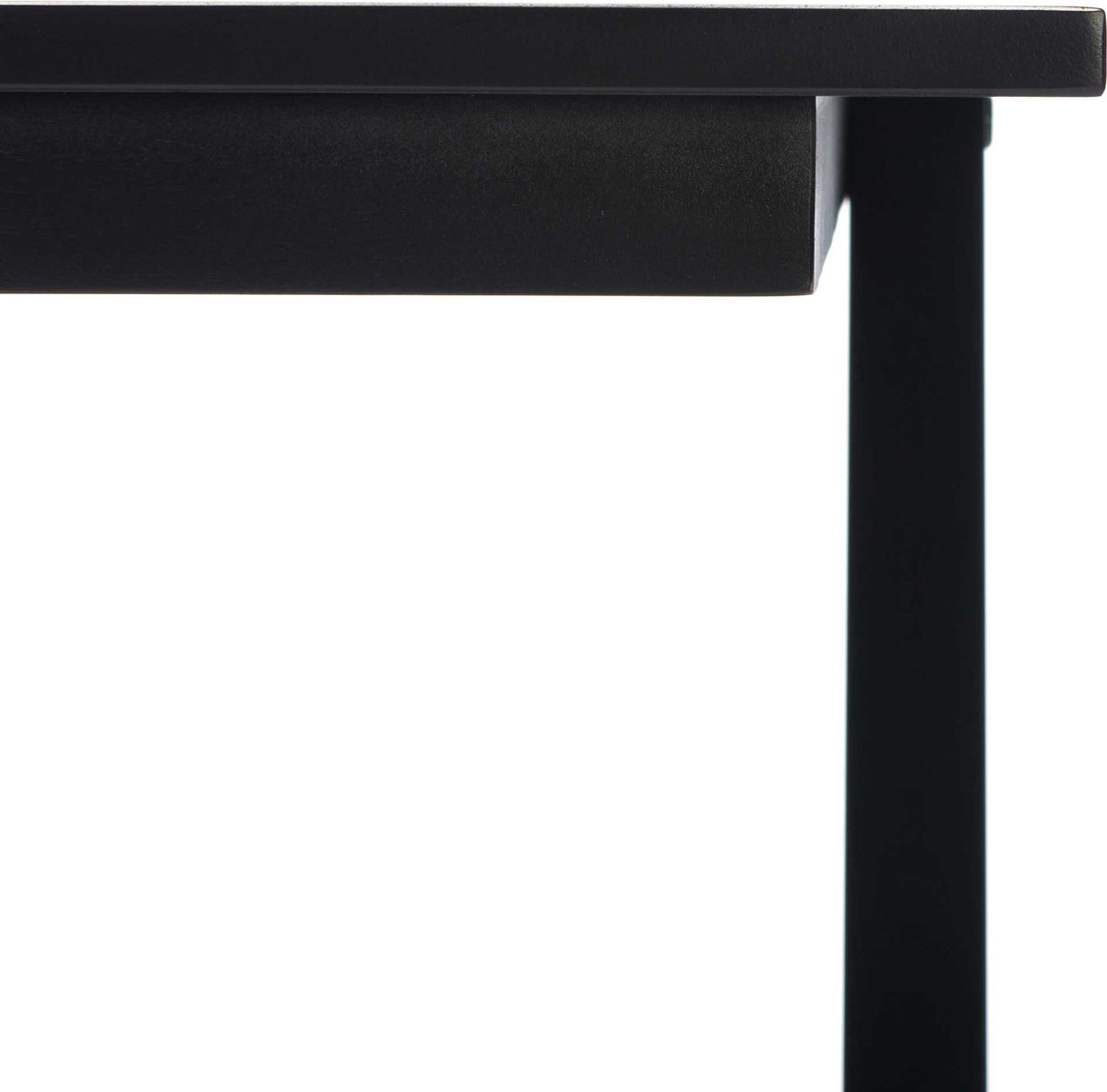 The smooth black tabletop and apron meet a clean-lined wood support.