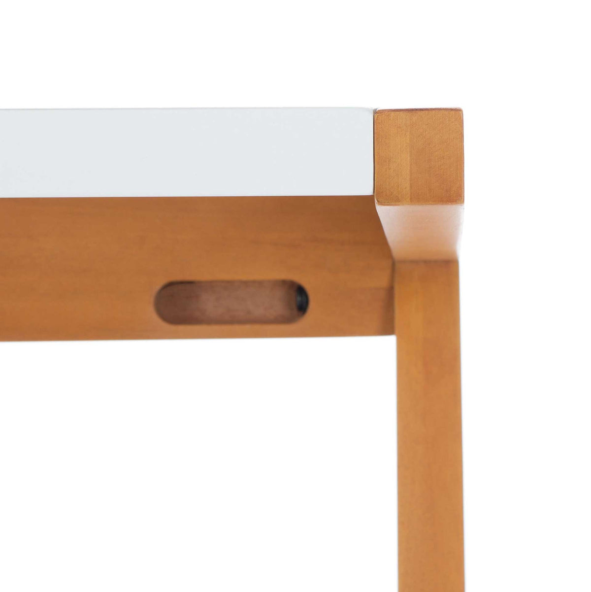 A white tabletop meets a warm wood frame, with a small recessed detail beneath the edge.