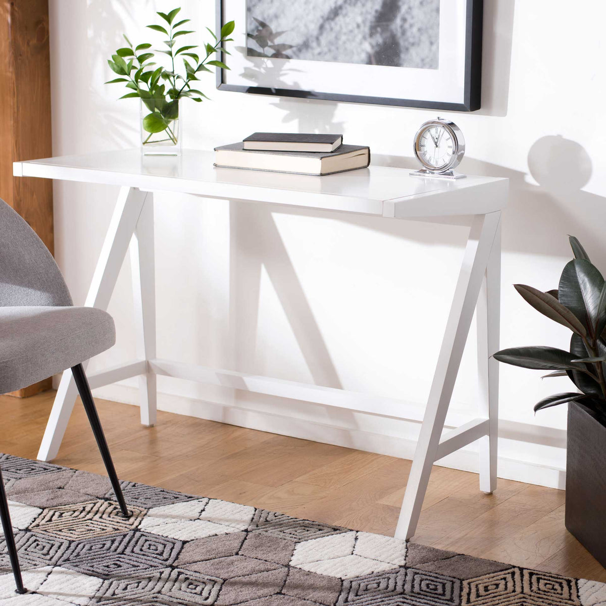 Bright white desk creates an airy workspace with angled legs and an open, uncluttered base.
