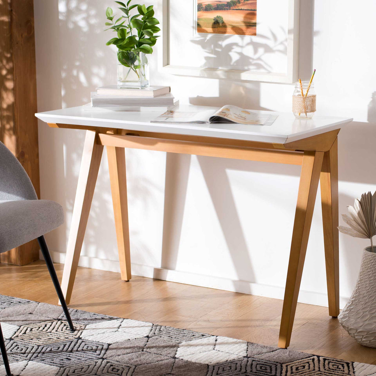 A bright white work surface and angled oak-toned legs bring warmth to a home workspace.