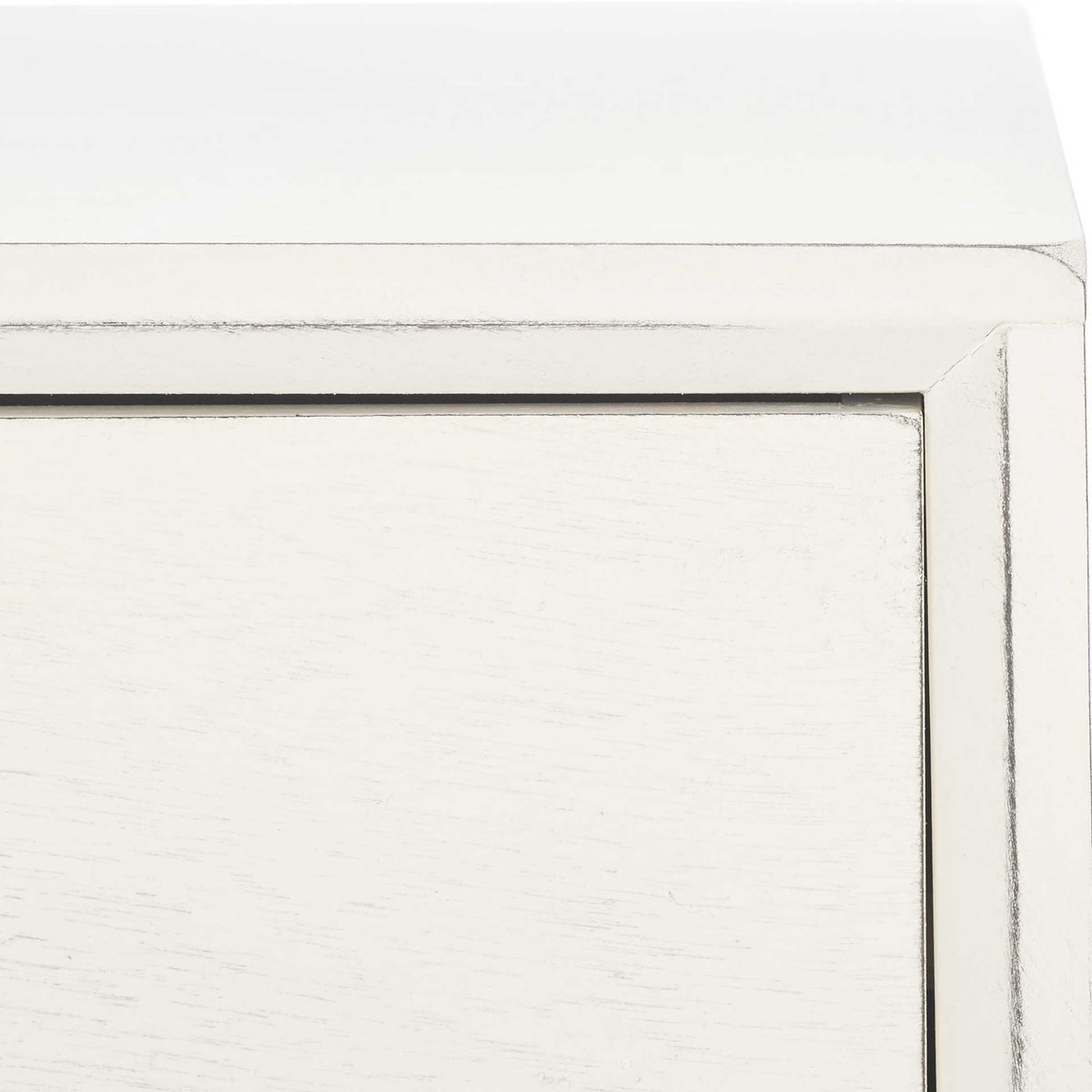 Subtly worn edges outline the white desk's framed drawer front and smooth tabletop
