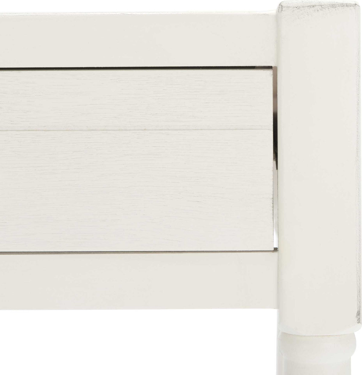 Faintly weathered edges and subtle wood grain enrich the white desk's framed drawer front