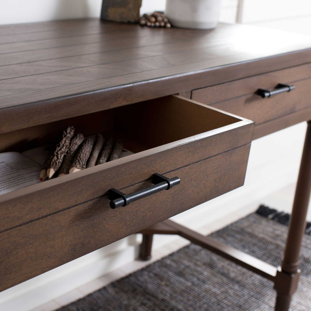 An open brown drawer keeps writing tools and everyday essentials within easy reach