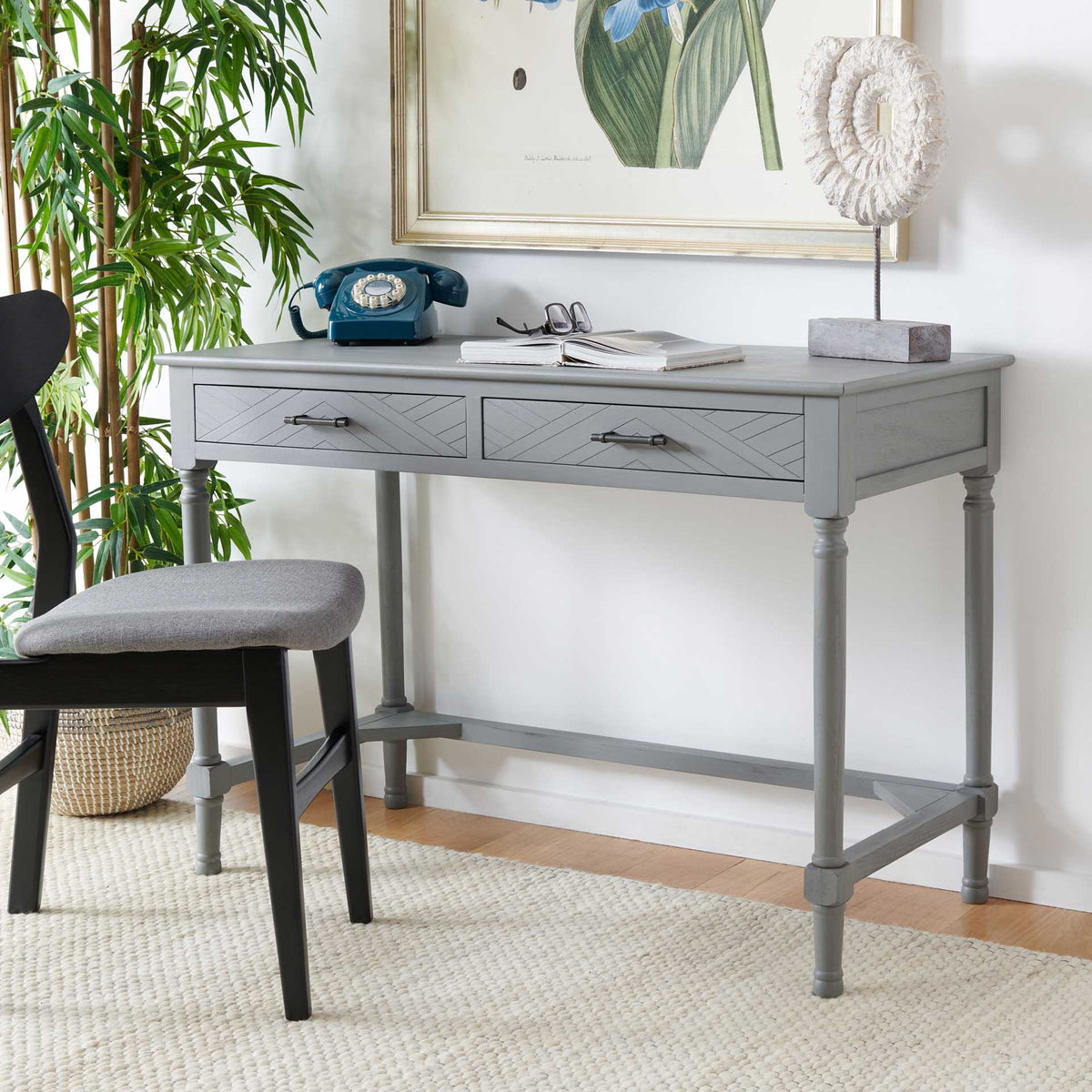 A gray desk with chevron drawers and turned legs creates an inviting place to work