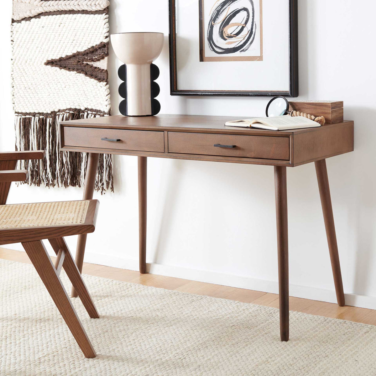 Warm brown desk with two storage drawers and slim legs complements a cozy workspace