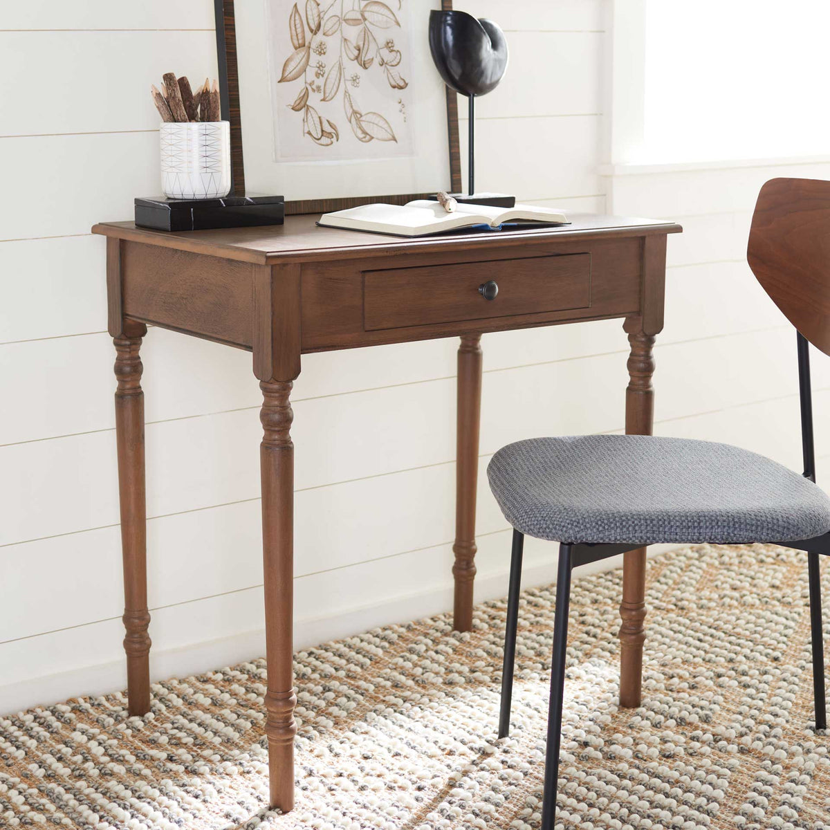 Warm brown desk creates an inviting workspace with its slim drawer and graceful turned legs