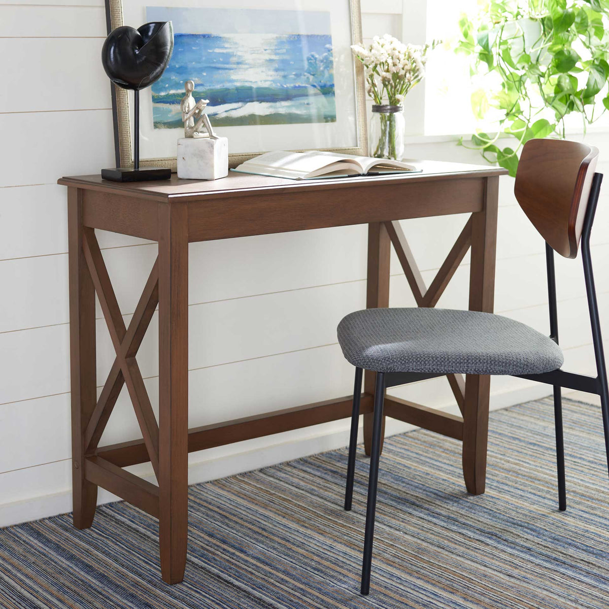 Warm brown desk creates an inviting workspace with a compact top and crossed side supports