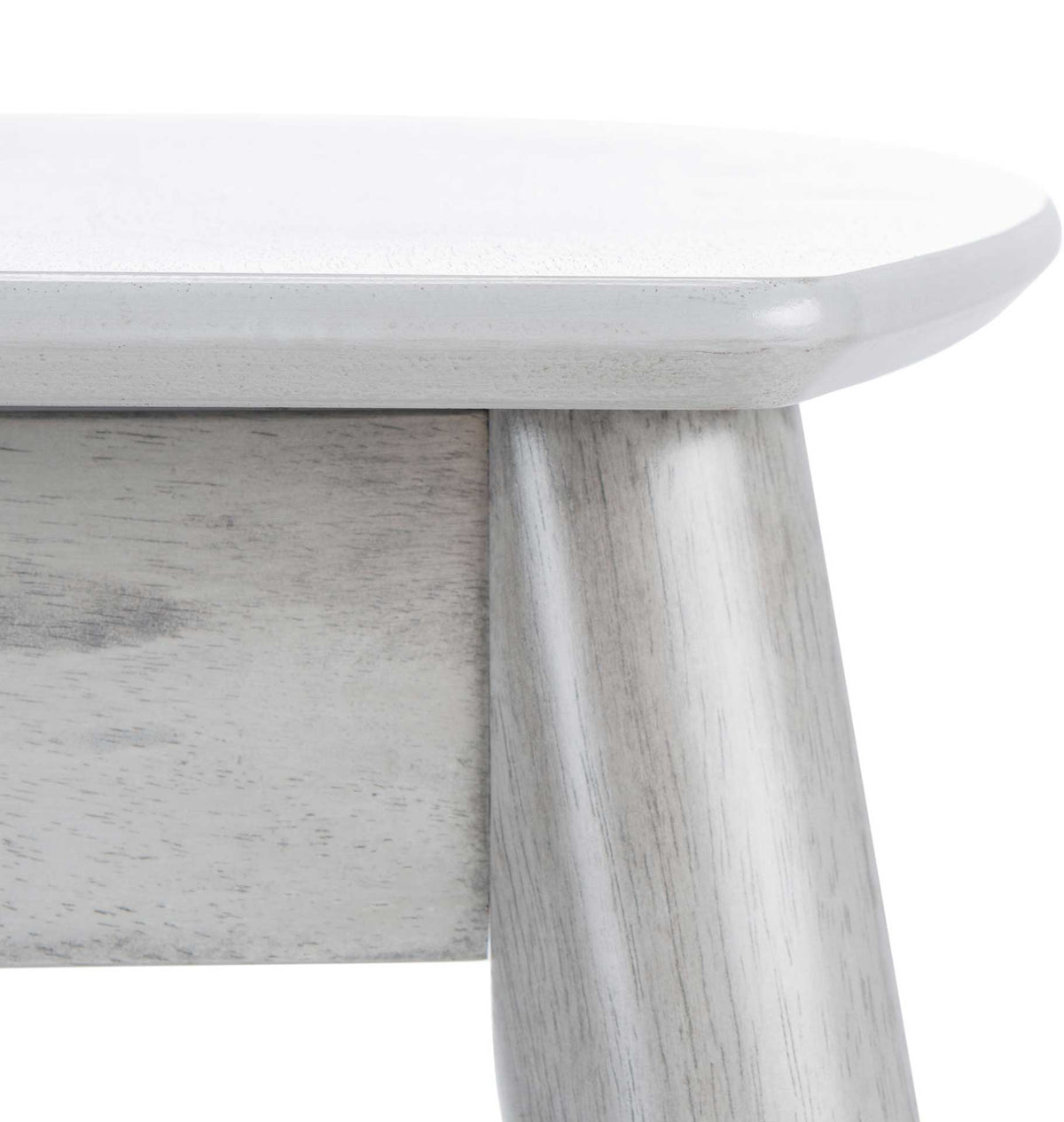 The smooth, rounded tabletop edge meets a tapered wood leg in a textured gray finish.