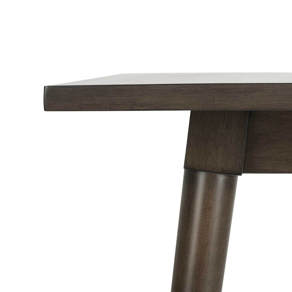 A sleek gray walnut tabletop meets the apron and an angled leg at a tailored corner joint.