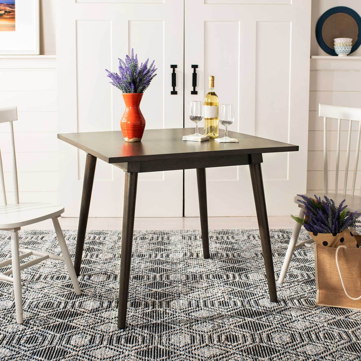 A square gray walnut dining table brings retro style to a cozy dining area.