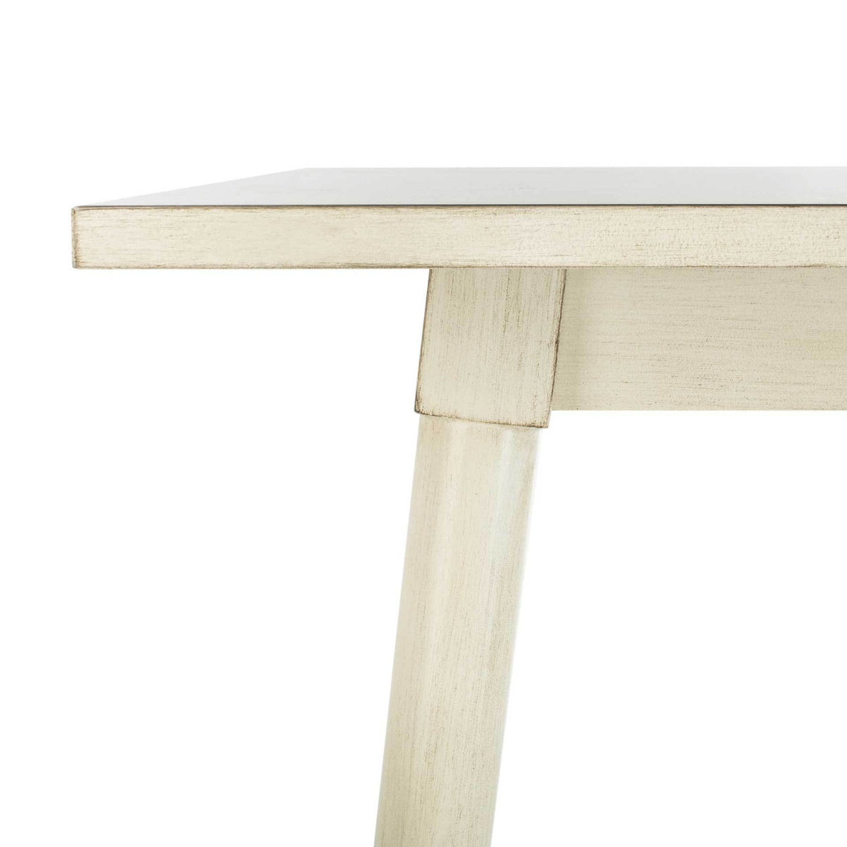 Subtle distressing accents the antique white tabletop edge and angled leg joint.