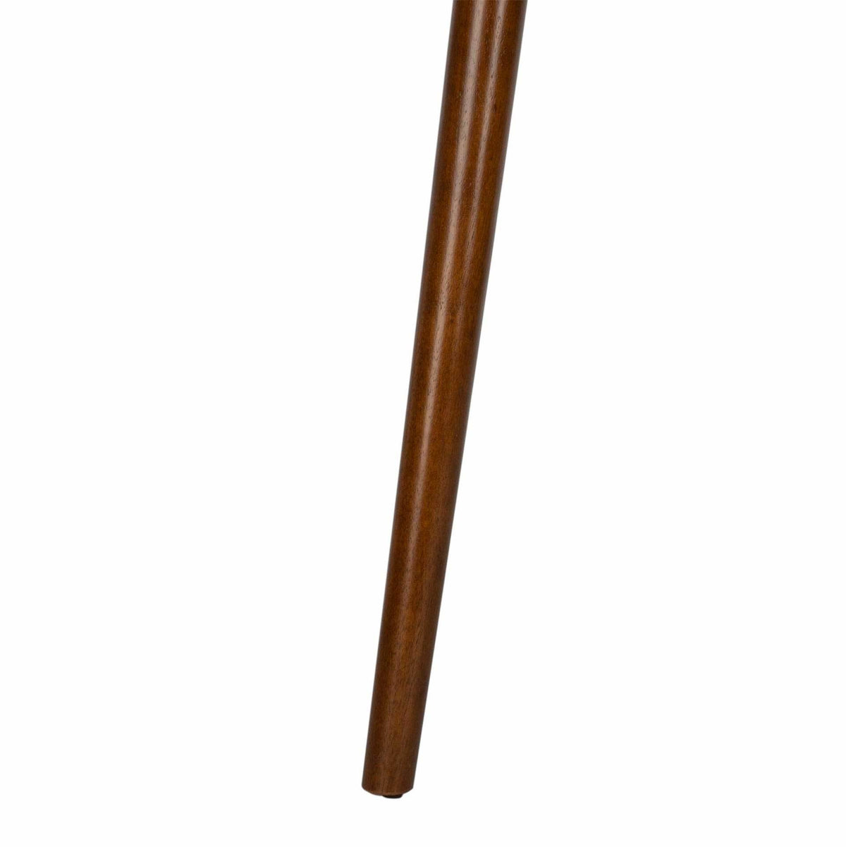 A slender, tapered table leg angles outward in a smooth walnut finish.