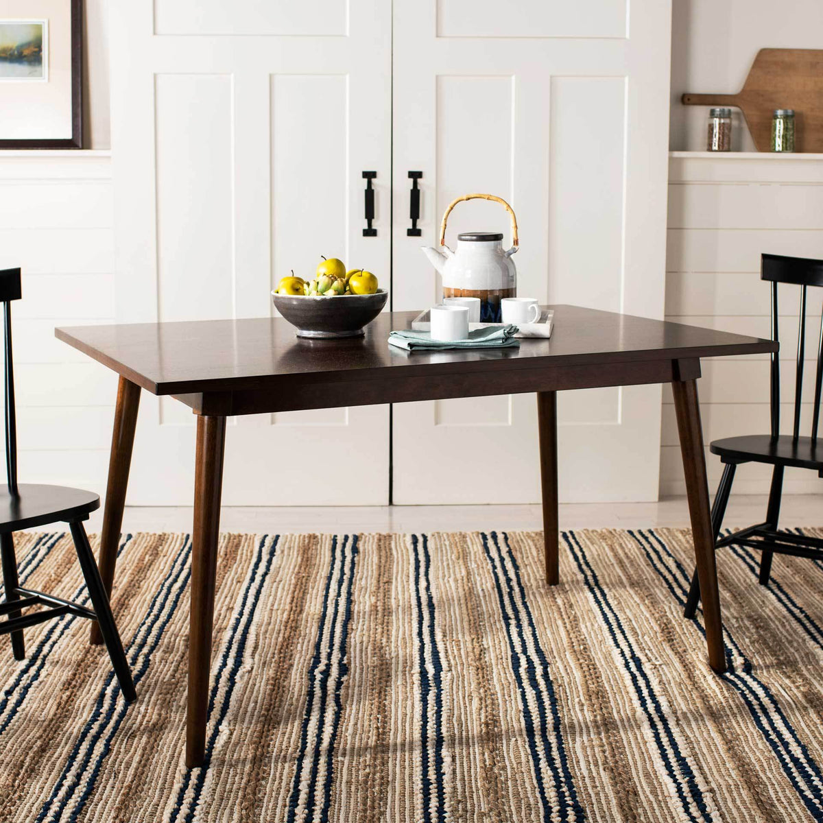This walnut-finished dining table brings a warm, clean-lined centerpiece to meals and gatherings.