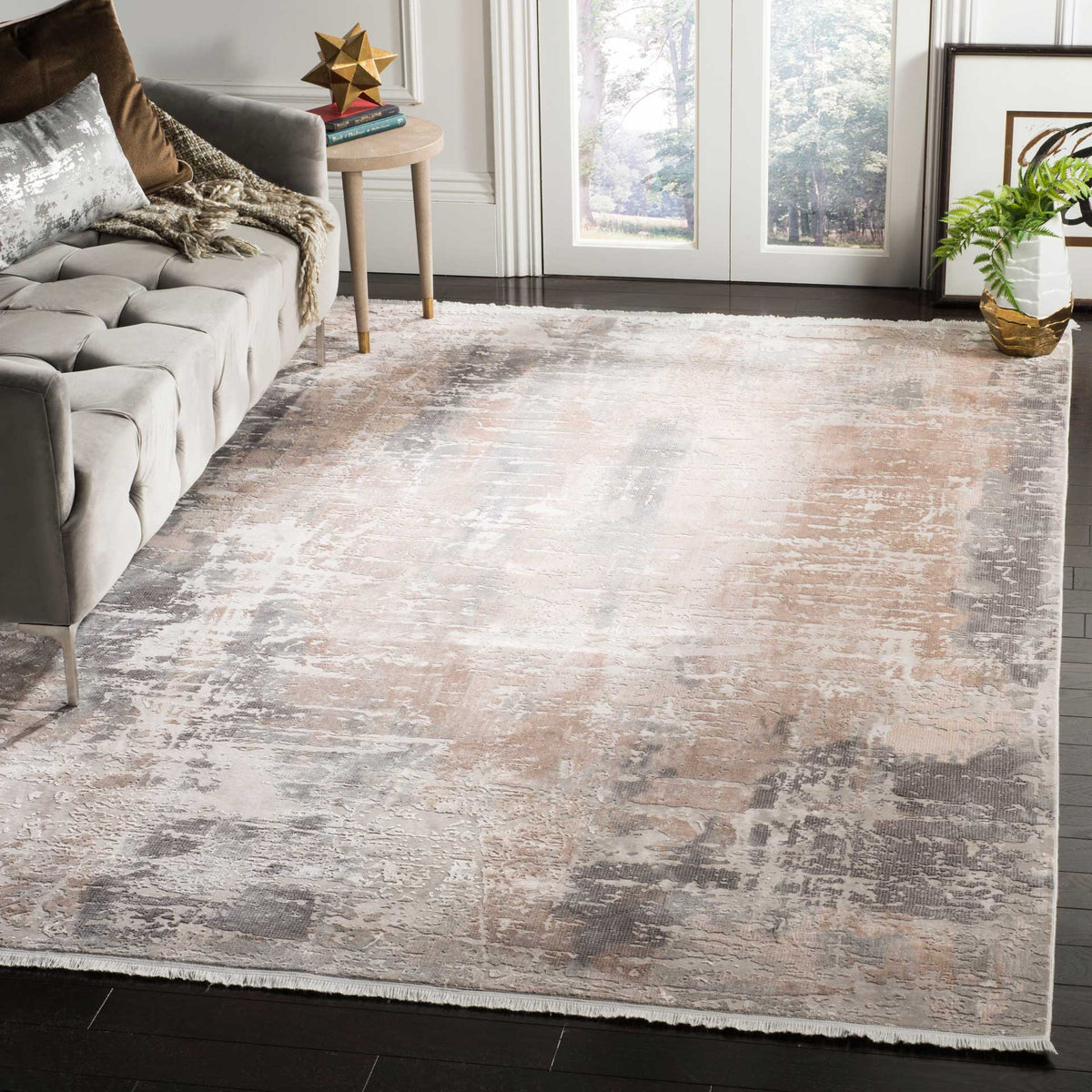 Soft beige and brown abstract patterning adds depth and warmth beneath a cozy seating area