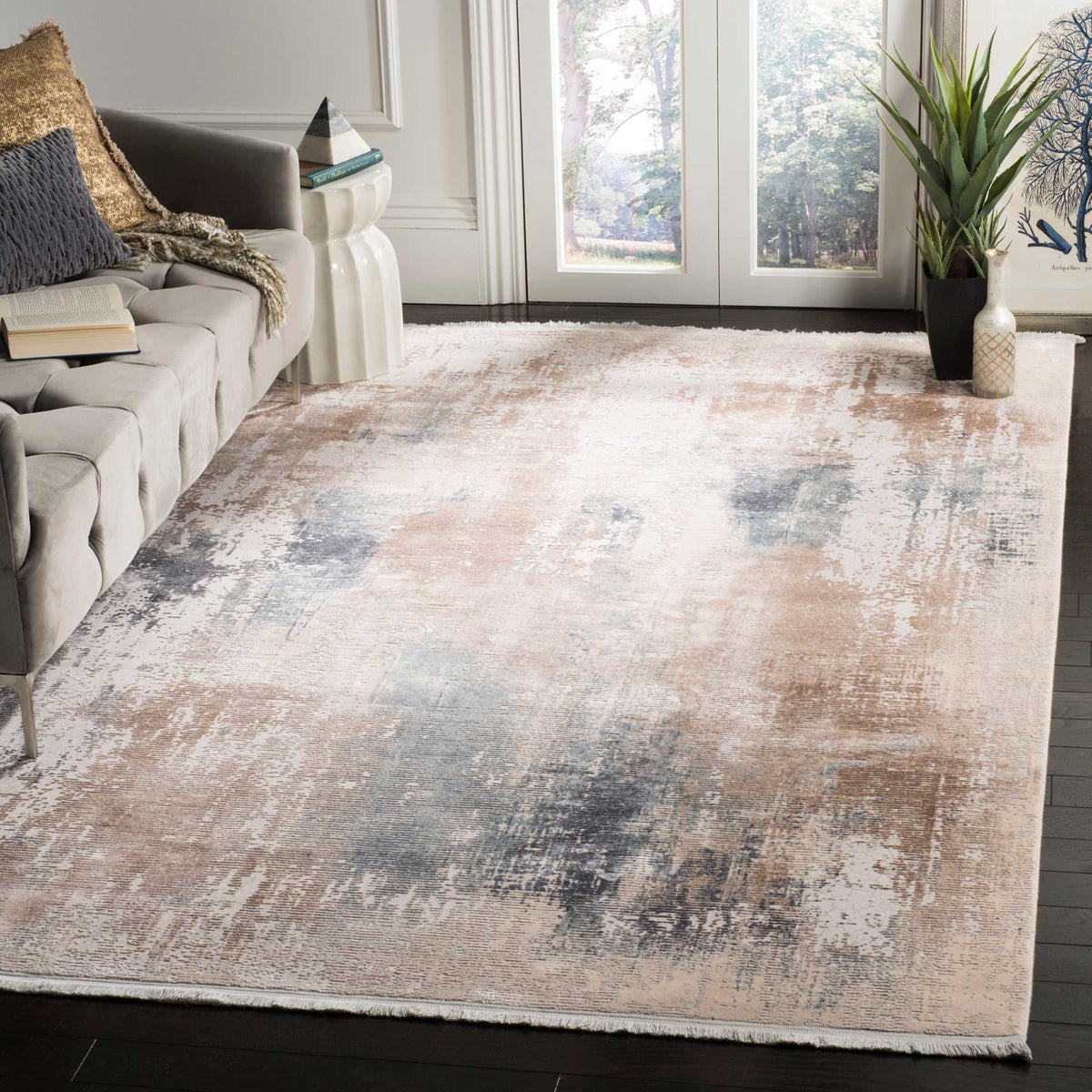 A beige and blue abstract rug brings painterly color and soft texture to a living space.