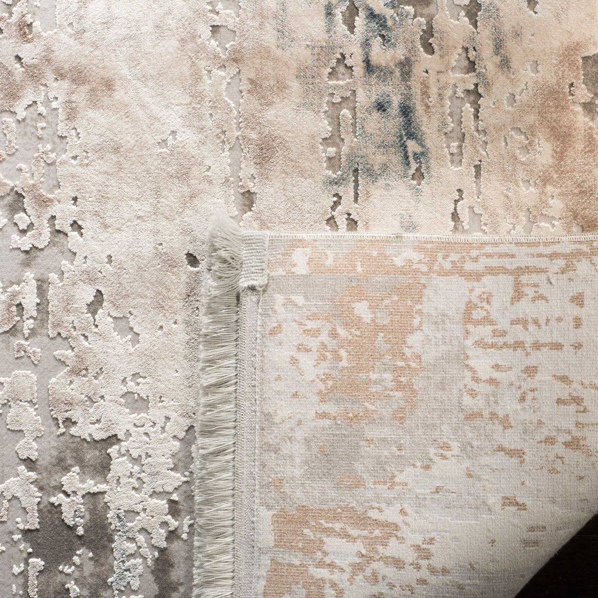 Soft abstract pile reveals a woven cotton backing and neatly finished fringe