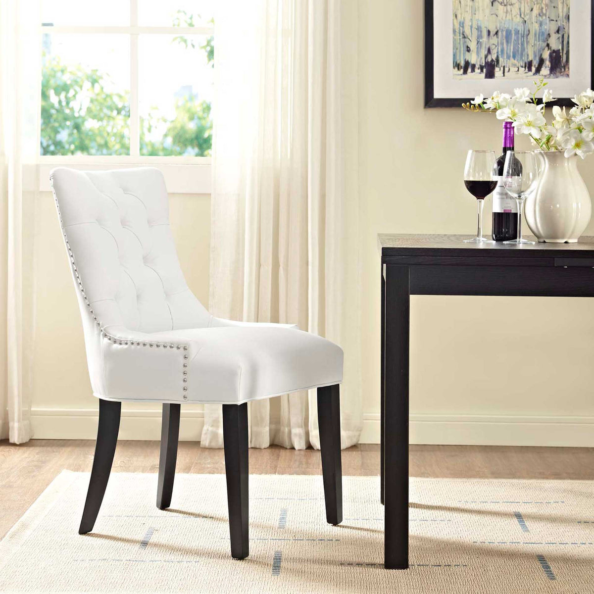 White tufted dining chair brings crisp contrast and cushioned comfort to a bright dining space.