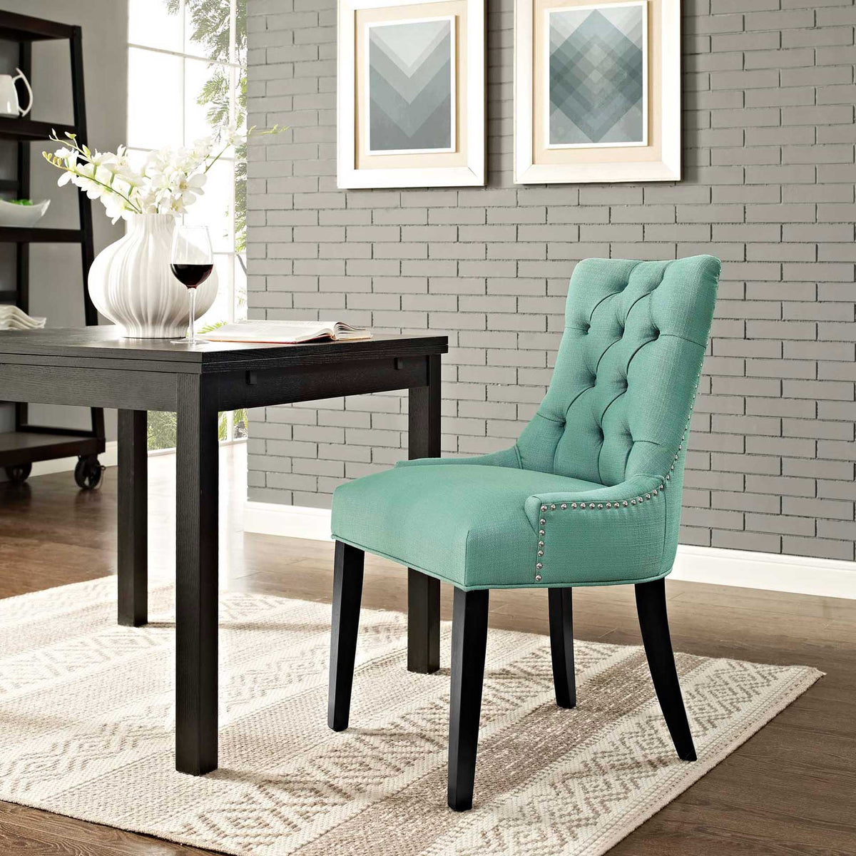Turquoise tufted dining chair adds a fresh pop of color alongside a dark dining table.